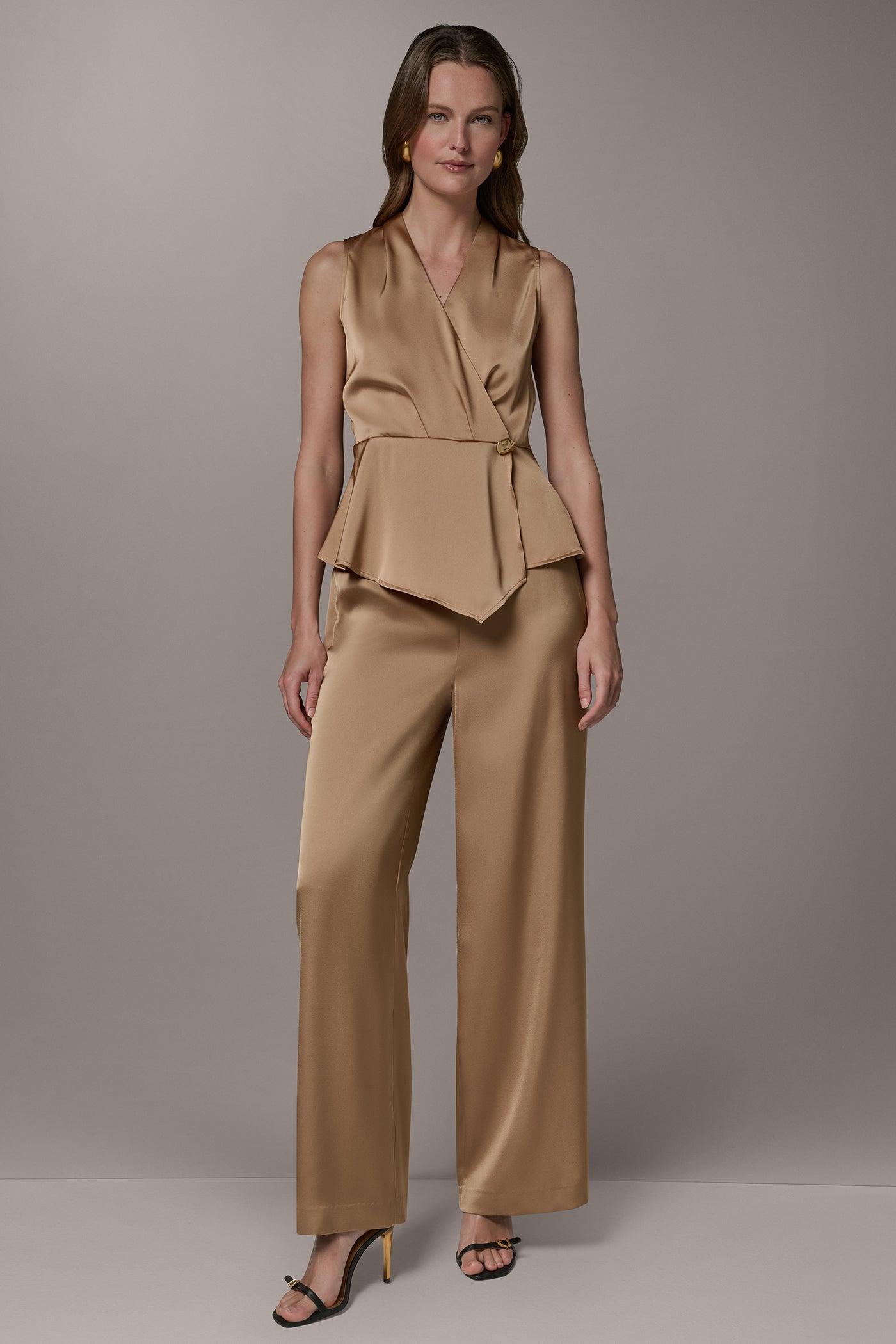 SLEEVELESS WRAP-EFFECT ASYMMETRIC PEPLUM BLOUSE