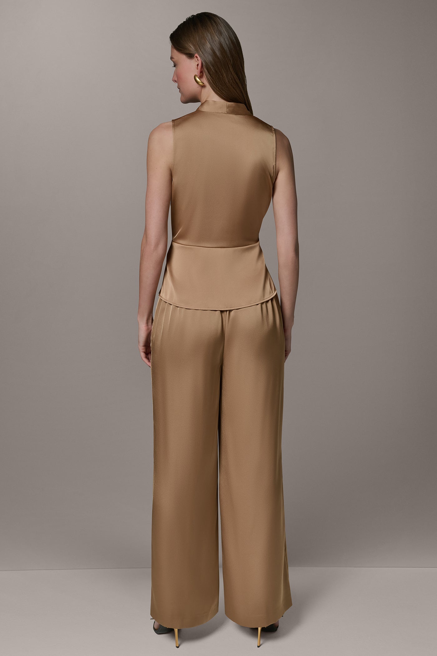 SLEEVELESS WRAP-EFFECT ASYMMETRIC PEPLUM BLOUSE