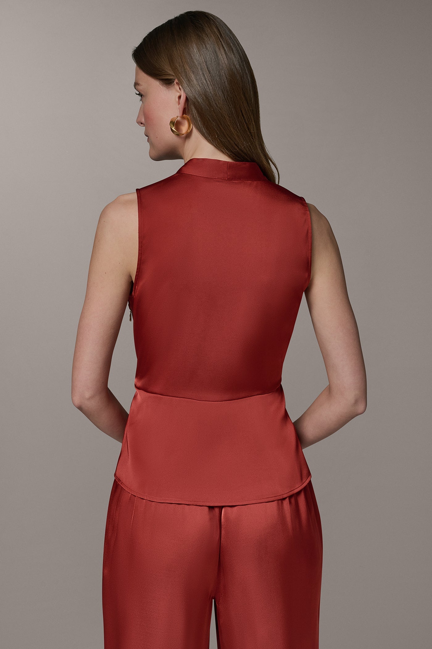 SLEEVELESS WRAP-EFFECT ASYMMETRIC PEPLUM BLOUSE